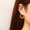 199Gold-Toned Heart-Shaped Hoop Earrings.
