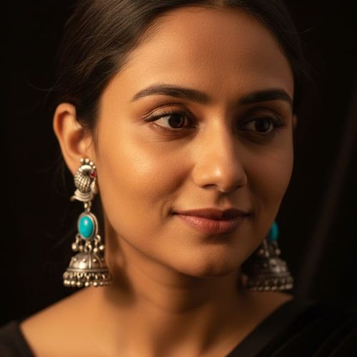 395c oxidized silver peacock jhumka earrings with turquoise stones and white pearl embellishments.