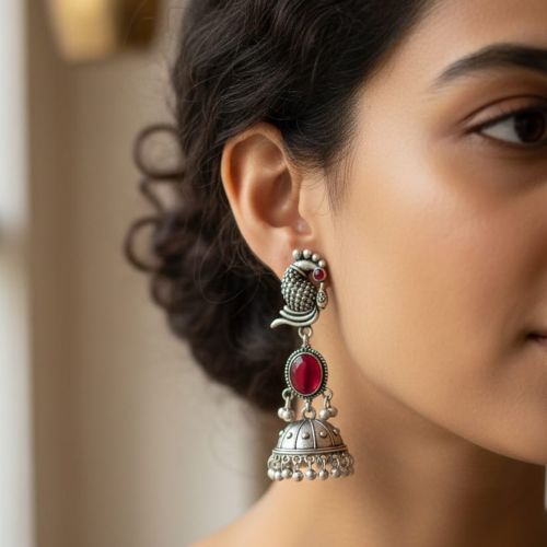 395b oxidized silver peacock jhumka earrings with turquoise stones and white pearl embellishments.