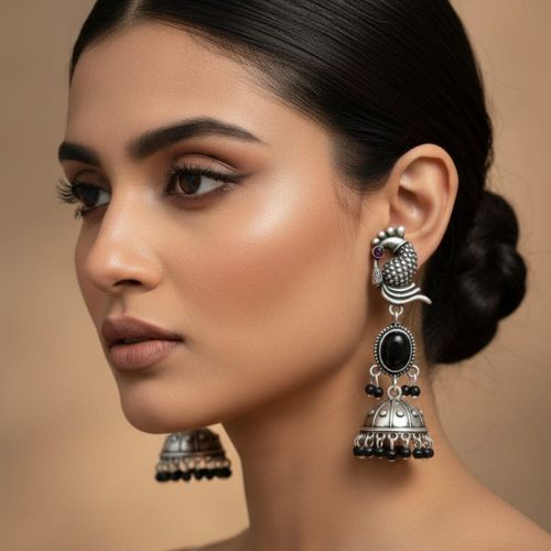 395d oxidized silver peacock jhumka earrings with turquoise stones and white pearl embellishments.